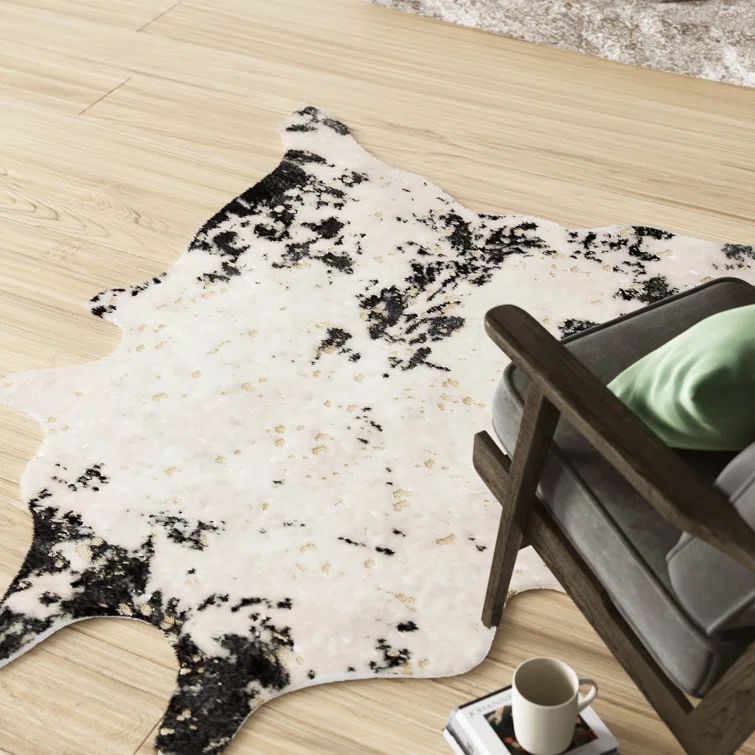Black and Ivory Tufted Synthetic Cowhide Shaped Area Rug