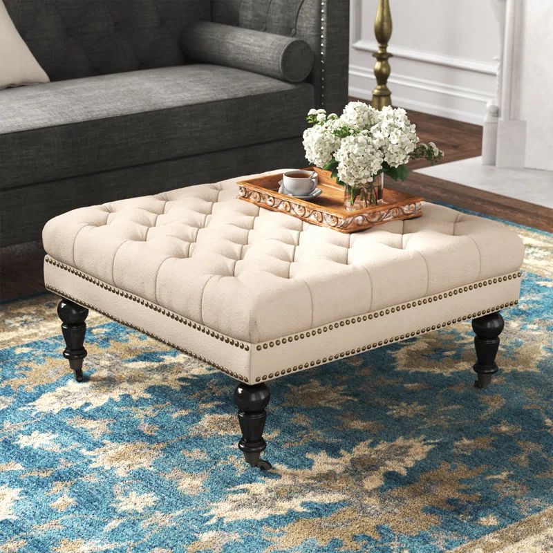 Isabelle 35" Tufted Linen Ottoman with Nailhead Accents