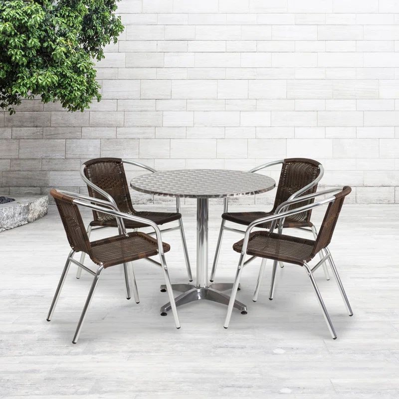 Silver Round Stainless Steel Dining Set with Beige Rattan Chairs