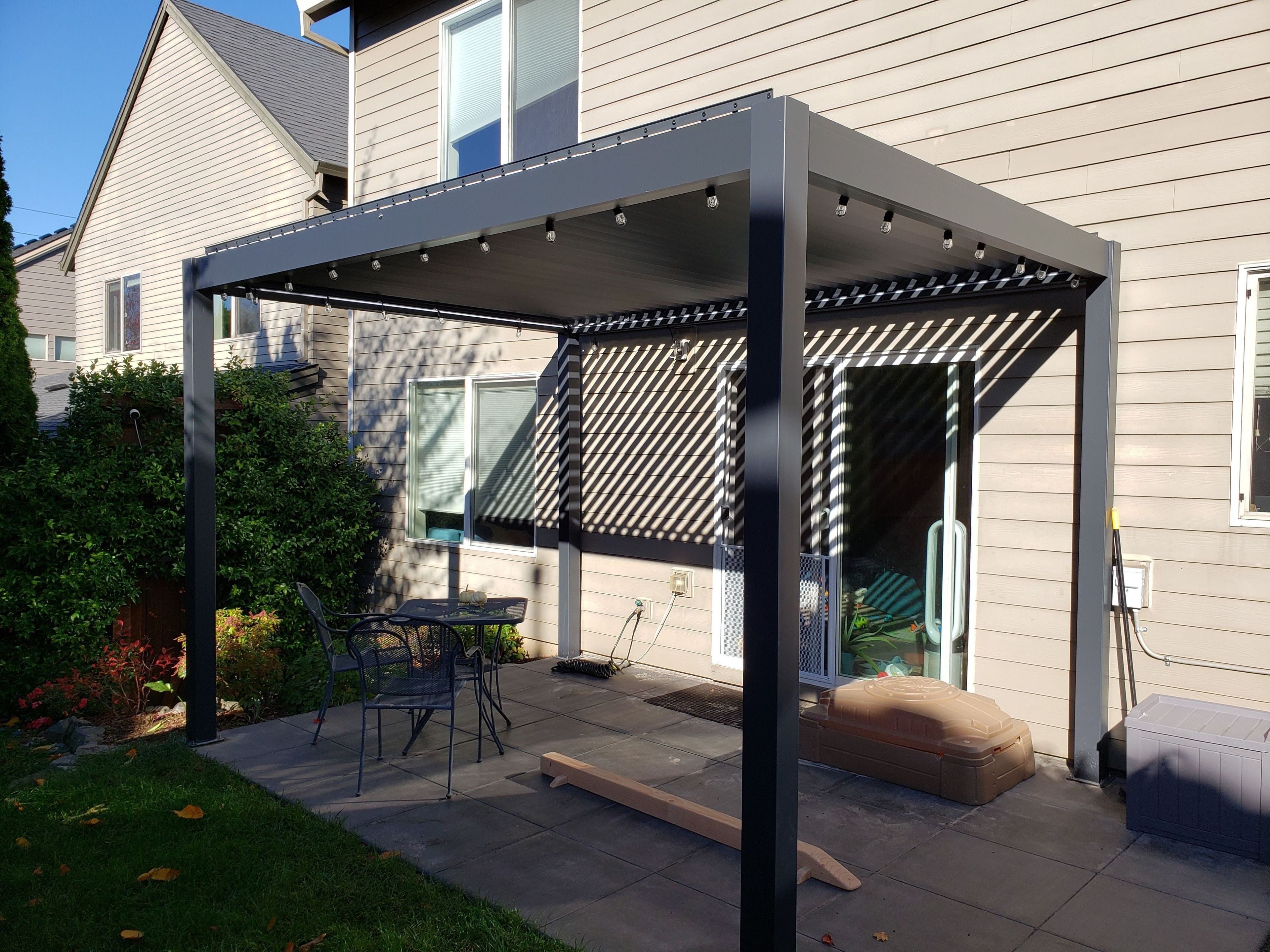 Dark Gray Aluminum Freestanding Pergola with Motorized Louvers and LED Lighting, 13' x 13'