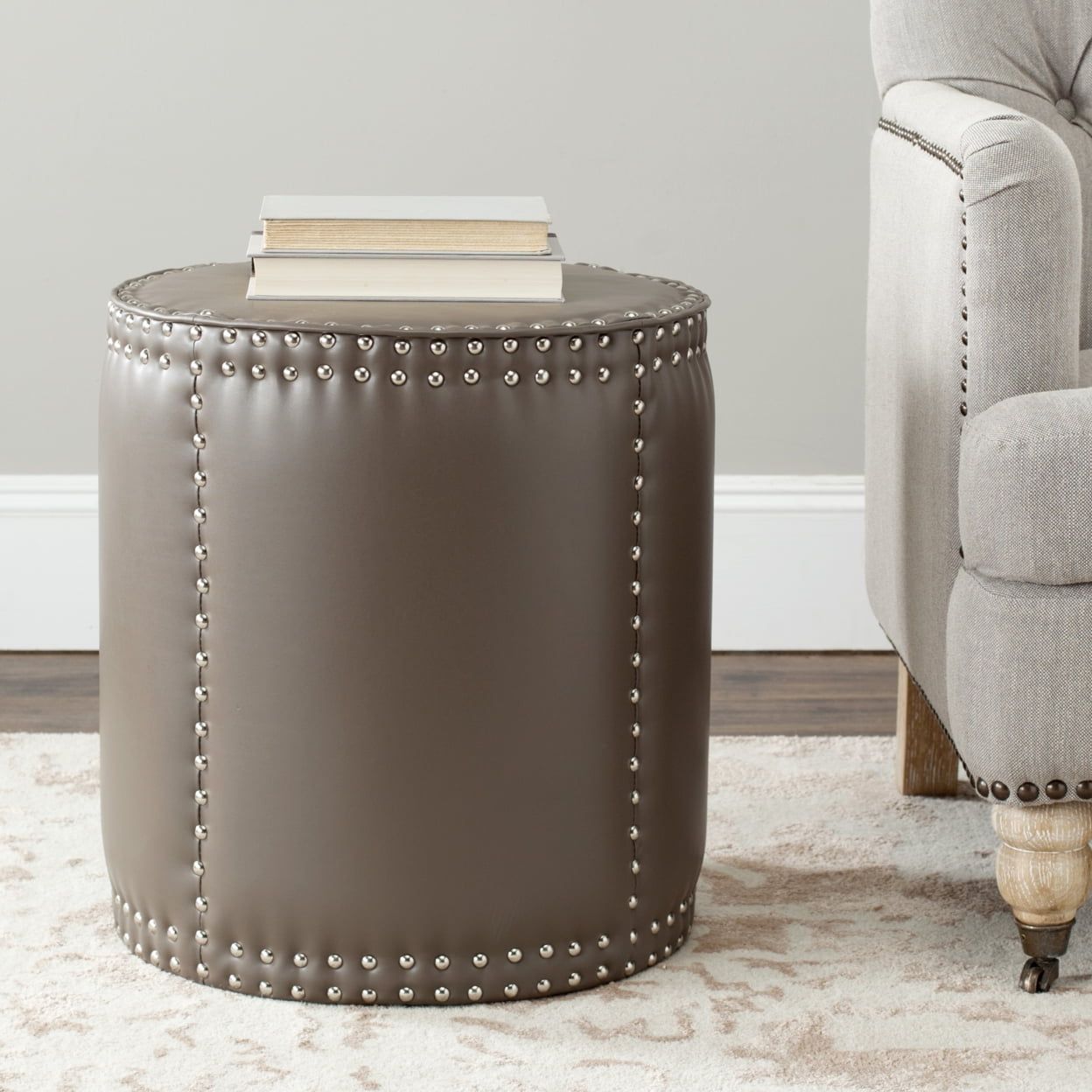 Clay Gray Bi-Cast Leather Round Ottoman with Brass Nailhead Trim