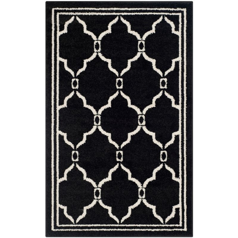 Ivory and Black Geometric Synthetic Area Rug