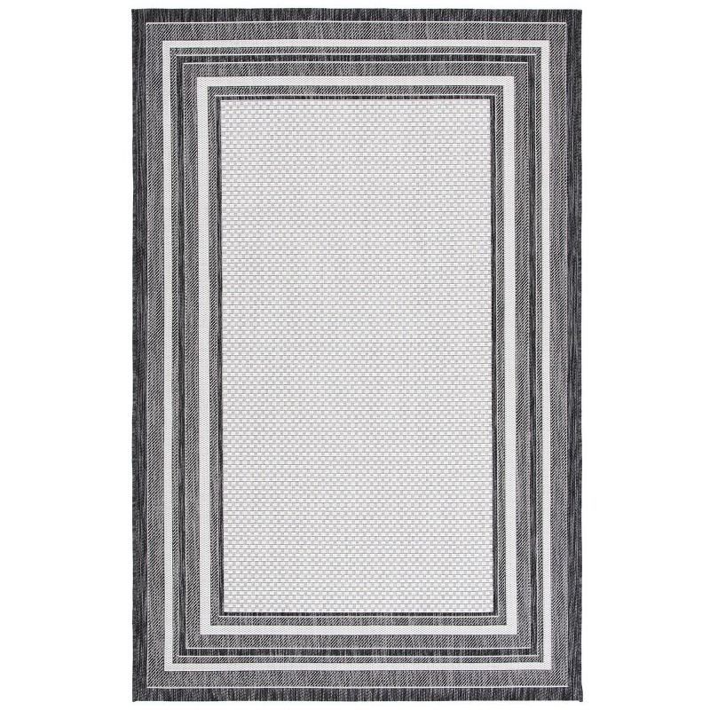 Ivory and Black Reversible Synthetic Indoor/Outdoor Rug