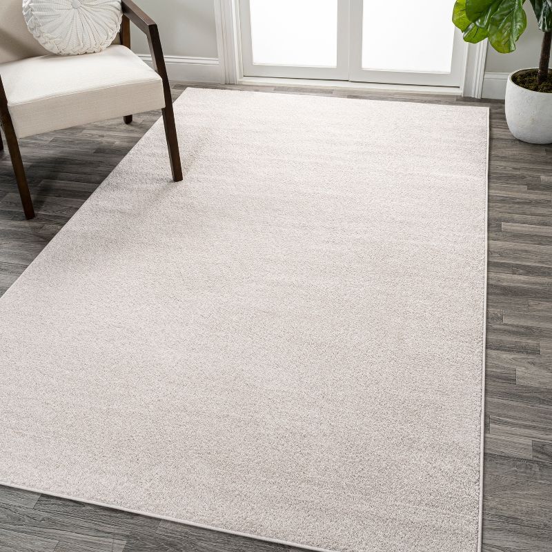 Ivory Solid Low-Pile Synthetic Area Rug, 5 x 8