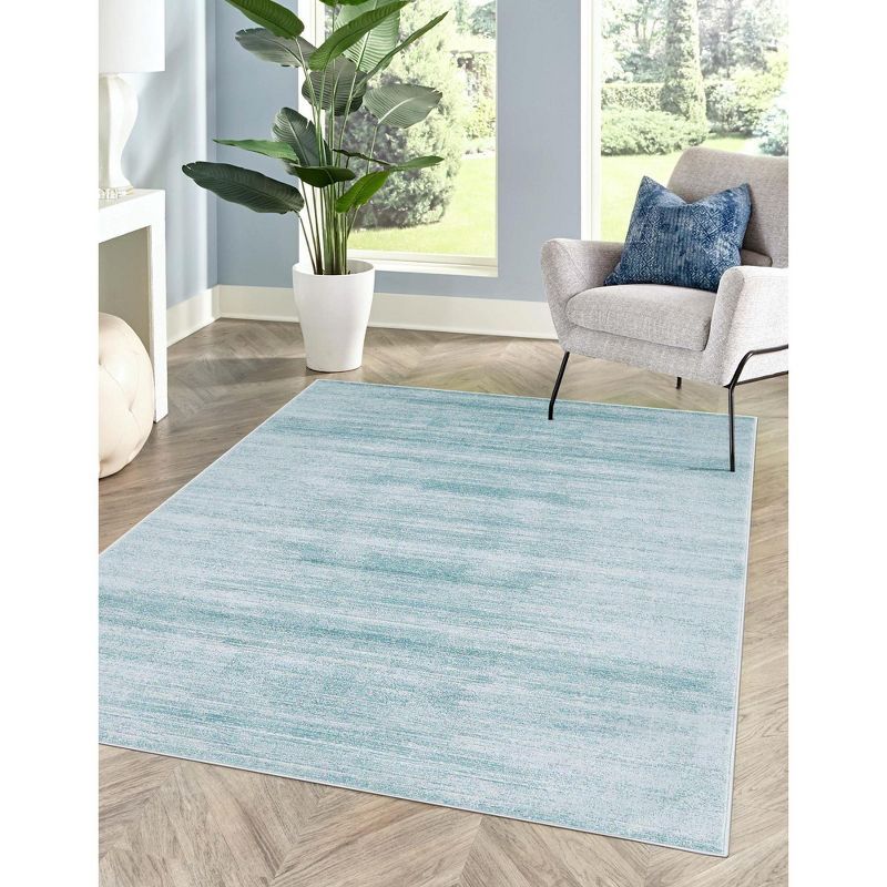 Turquoise and Ivory 8' x 10' Washable Synthetic Area Rug