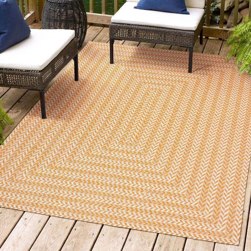 4' x 6' Ivory and Orange Geometric Synthetic Area Rug