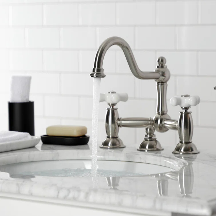 Kingston Brass Restoration Two-Handle 3-Hole Deck Mount Bridge Bathroom Faucet with Brass Pop-Up
