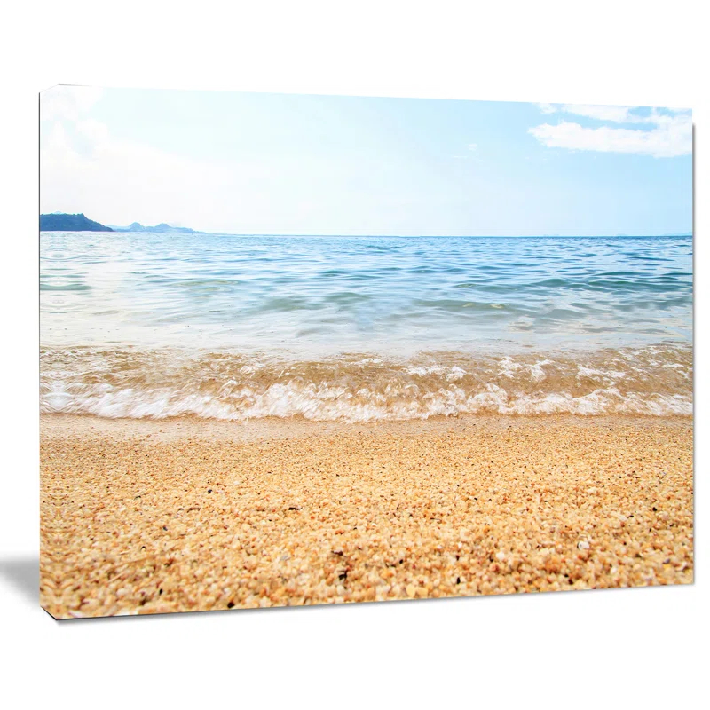 Design Art Blue Seashore with Pebble Stones Photographic Print on Wrapped Canvas