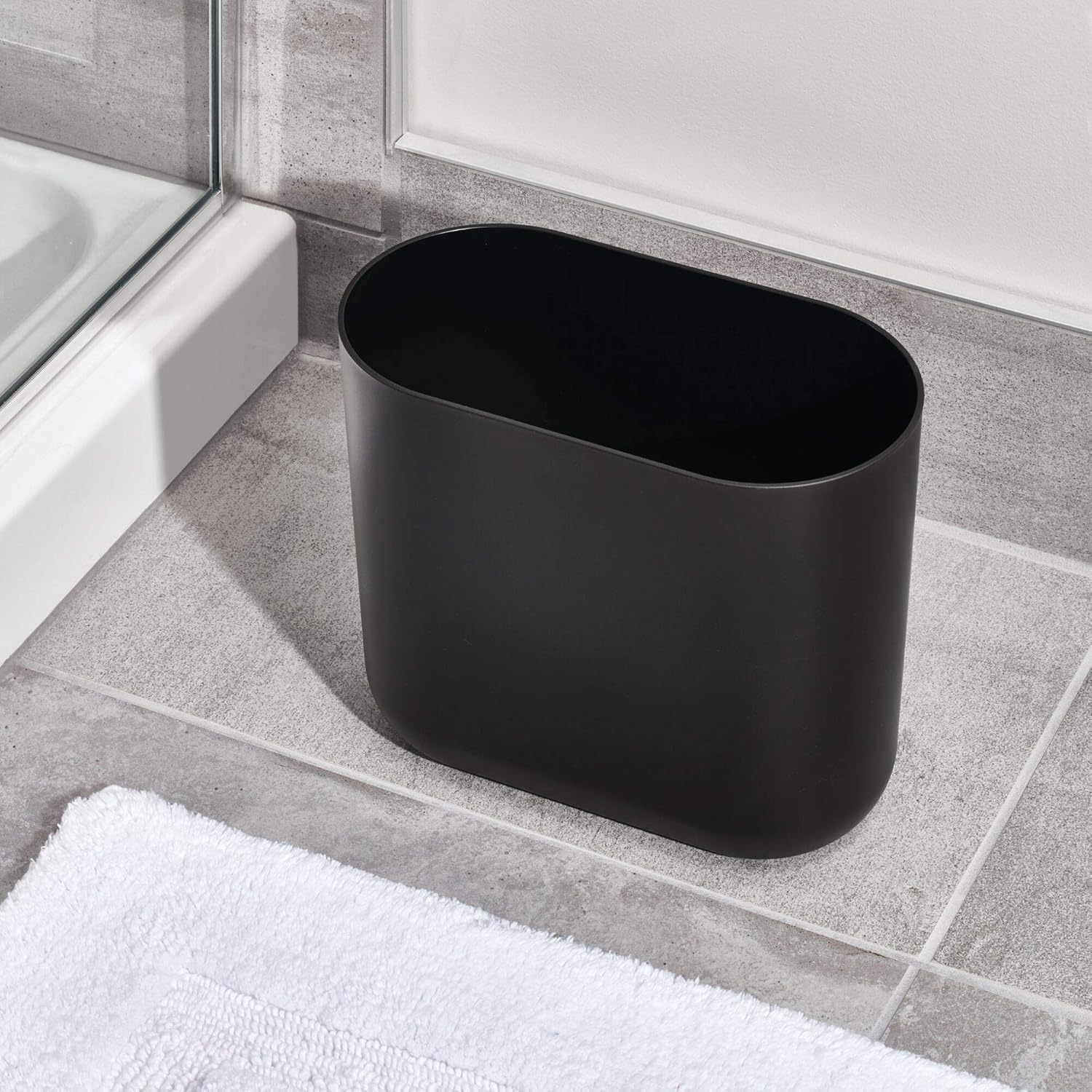 iDesign Slim Oval Plastic Waste Basket, The Cade Collection – 10.56” x 5.5” x 9.77”, Matte Black