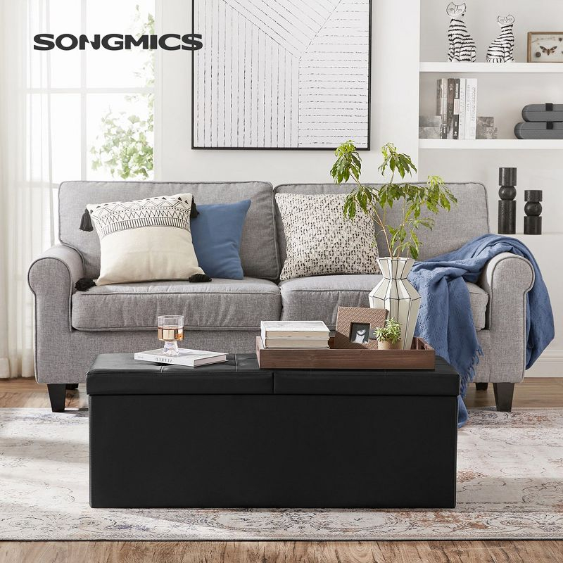 SONGMICS 43" Folding Storage Ottoman Bench Leather Ottoman Storage Footrest Hold up to 660lb Black