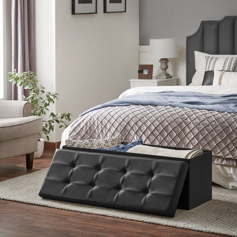 SONGMICS 43" Folding Storage Ottoman Bench Leather Ottoman Storage Footrest Hold up to 660lb Black