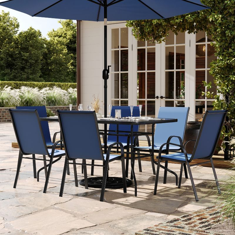 Flash Furniture Brazos 7 Piece Outdoor Patio Dining Set - 55" Tempered Glass Patio Table with Umbrella Hole, 6 Navy Flex Comfort Stack Chairs