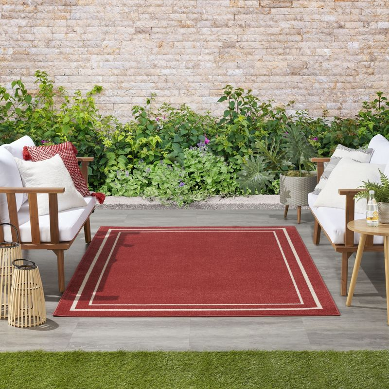 Nourison Essentials Solid Bordered Low Pile Indoor Outdoor Area Rug 5' x 7' Brick/Ivory