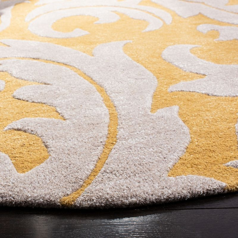 Soho SOH841 Hand Tufted Indoor Area Rug - Gold/Ivory - 6' round - Safavieh.