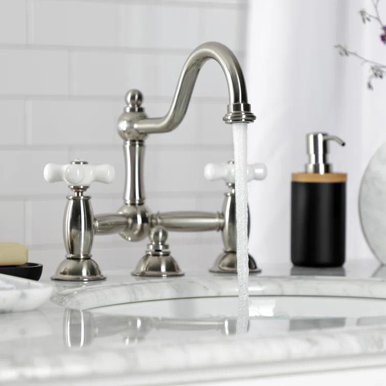Kingston Brass Restoration Two-Handle 3-Hole Deck Mount Bridge Bathroom Faucet with Brass Pop-Up