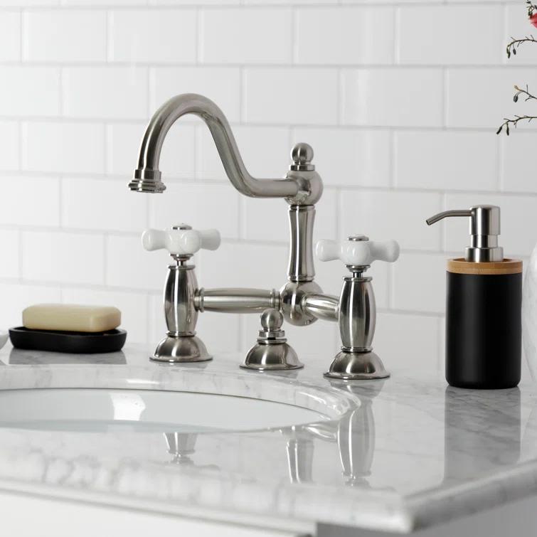 Kingston Brass Restoration Two-Handle 3-Hole Deck Mount Bridge Bathroom Faucet with Brass Pop-Up