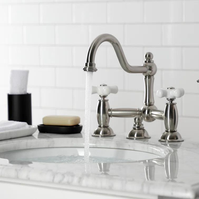 Kingston Brass Restoration Two-Handle 3-Hole Deck Mount Bridge Bathroom Faucet with Brass Pop-Up