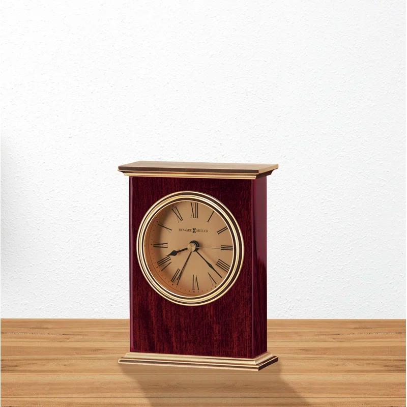 Howard Miller® Laurel Traditional Roman Numeral Wood Quartz Movement / Crystal Tabletop Clock with Alarm in Rosewood Hall/Polished Brass