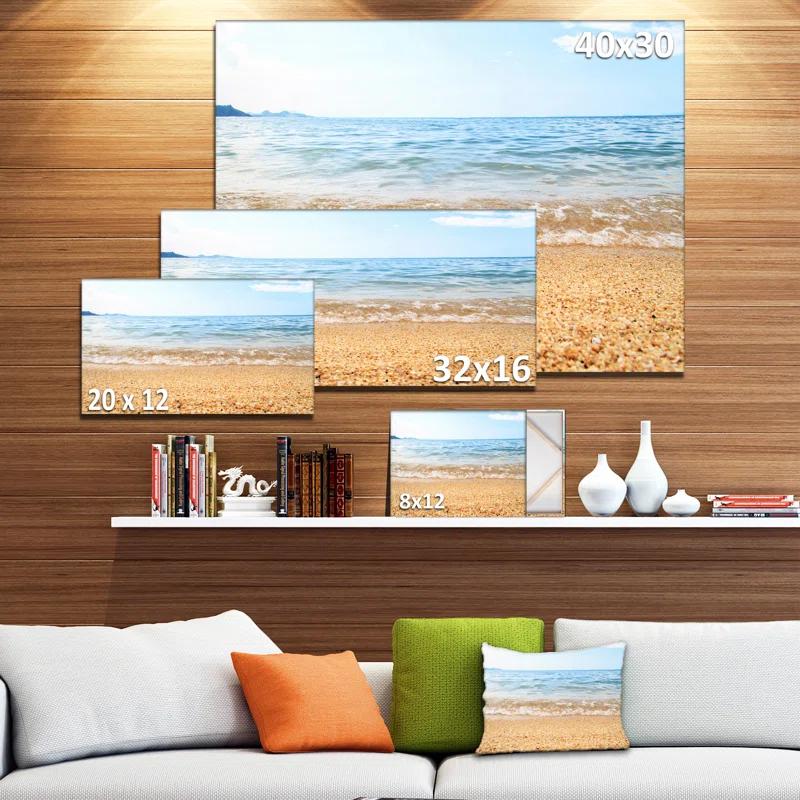 Design Art Blue Seashore with Pebble Stones Photographic Print on Wrapped Canvas