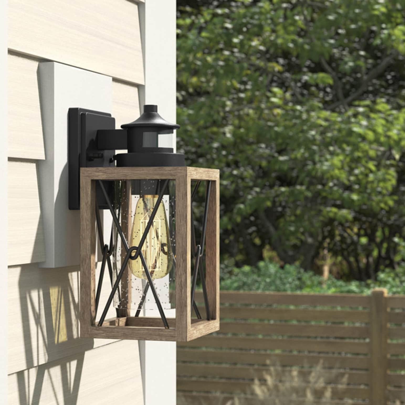 C Cattleya 1-Light Black and Faux Wood Motion Sensing Dusk to Dawn Outdoor Wall Light with Clear Seeded Glass