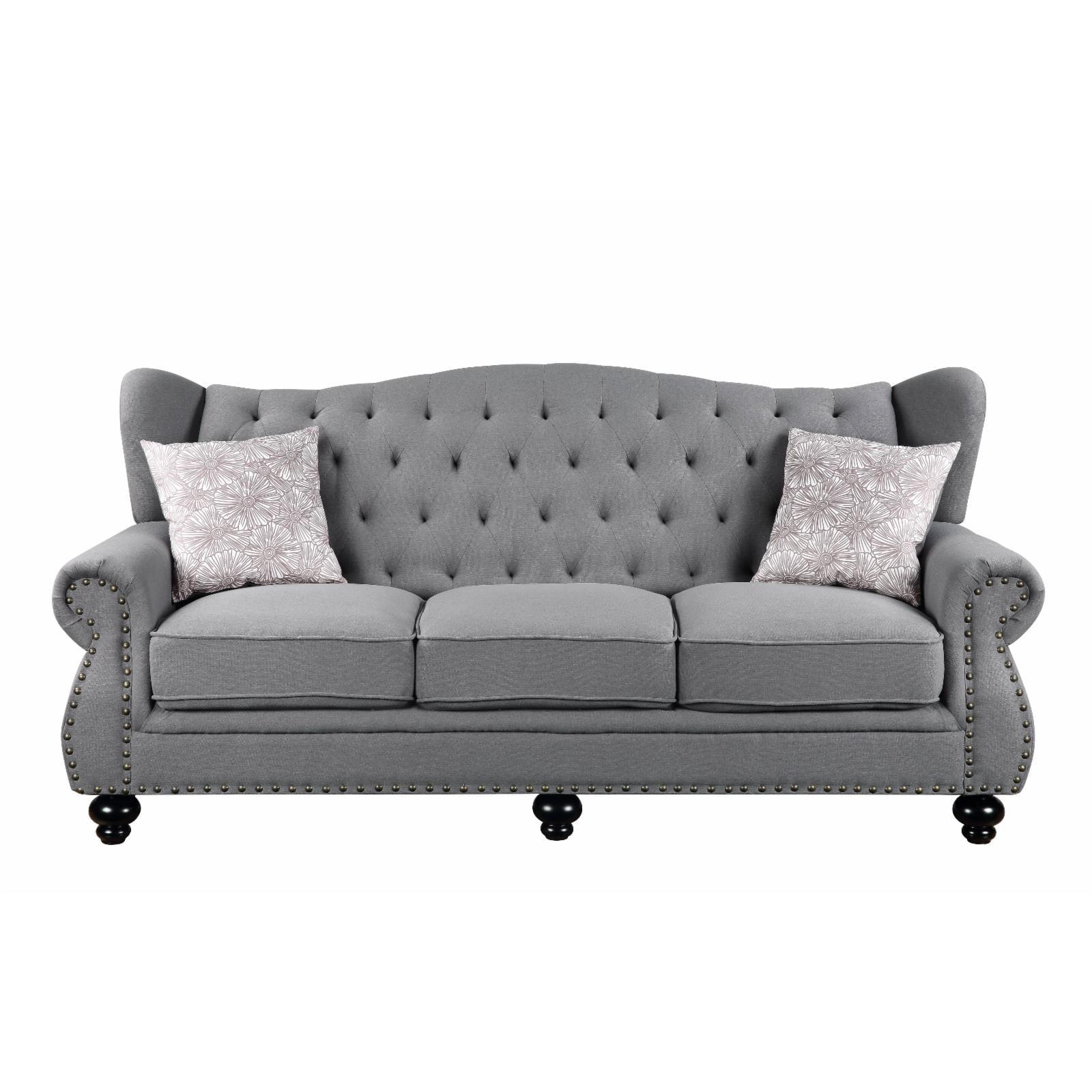 Gray Fabric Camelback Sofa with Floral Cushions and Nailhead Trim