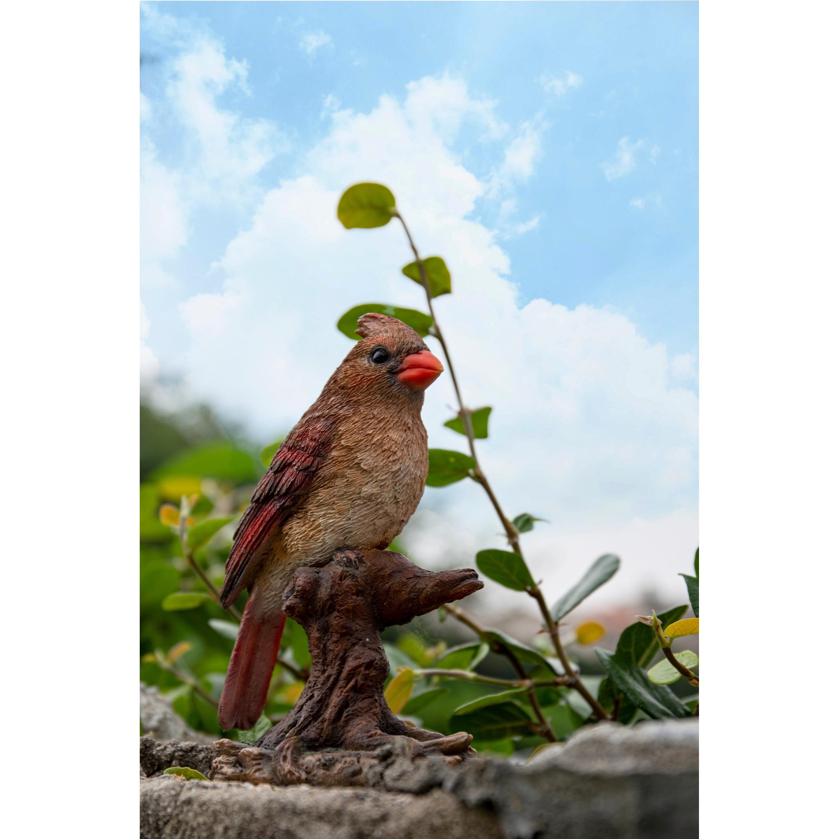 Female Cardinal Perched On A Stump Statue