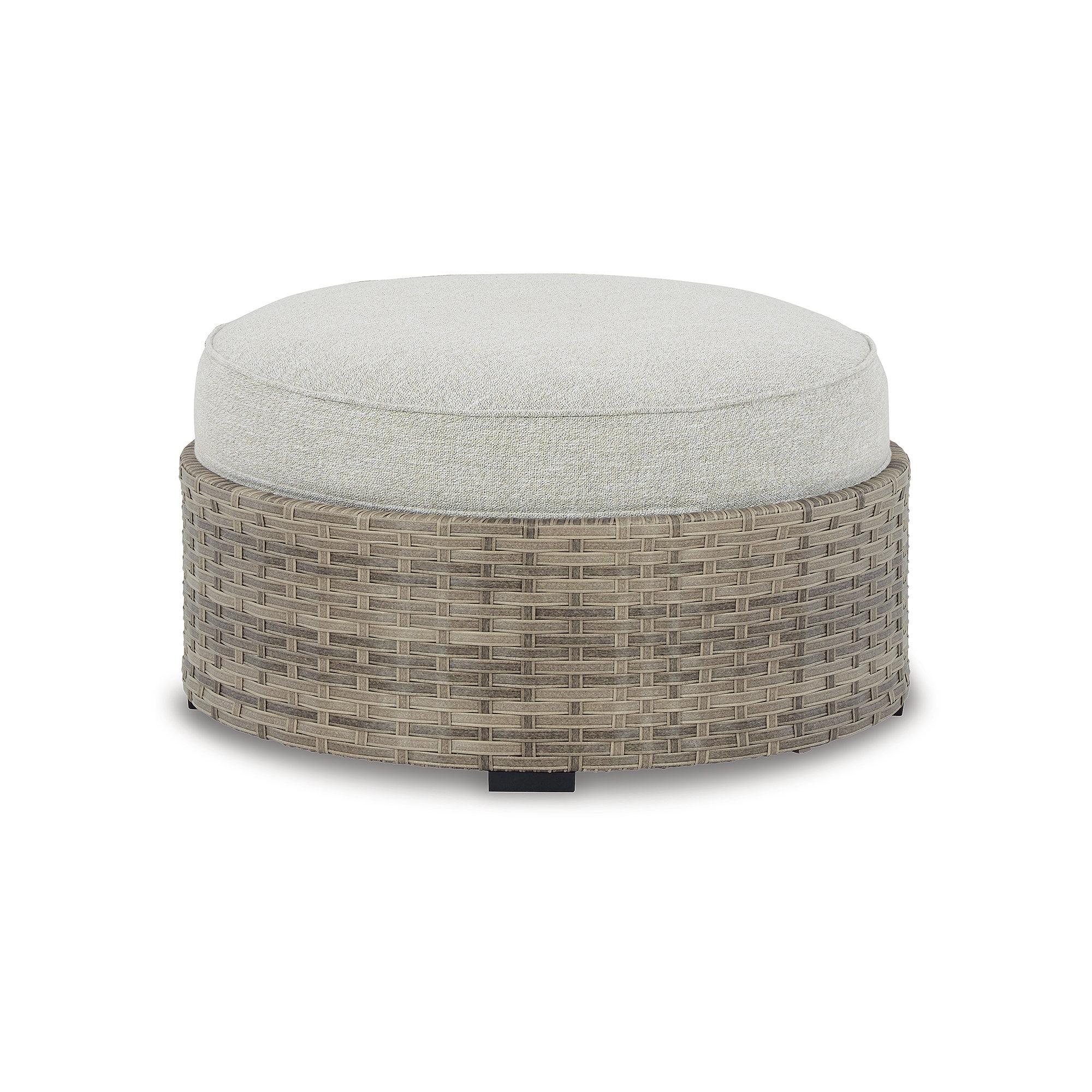 Calworth Handwoven Wicker Outdoor Ottoman with Performance Beige Cushion