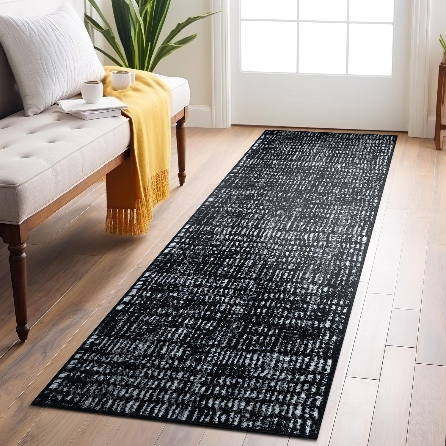 Black and Ivory Geometric Polypropylene Area Rug 2' x 7'