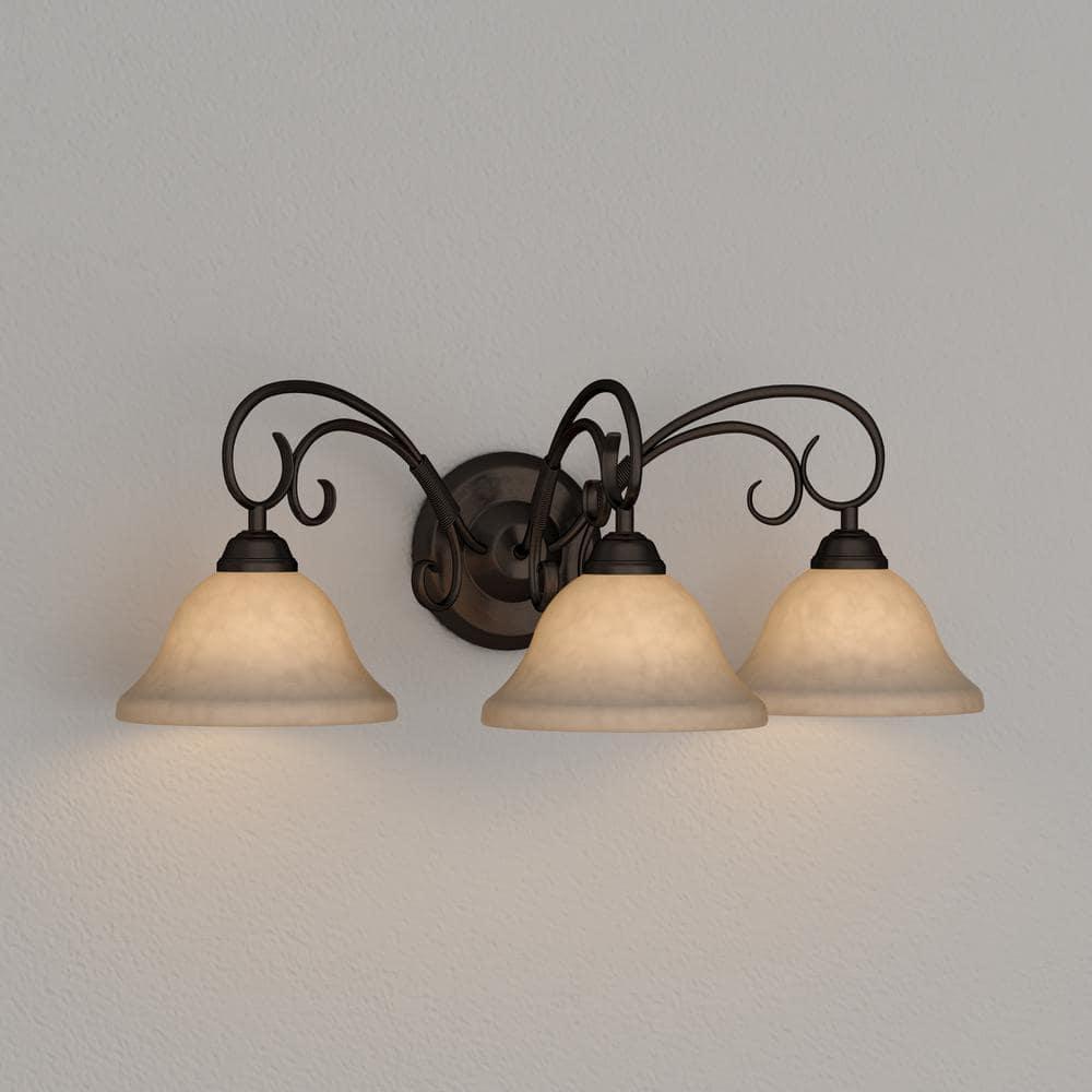 Golden Lighting Homestead 3-Light Vanity Light in Rubbed Bronze with Tea Stone Glass
