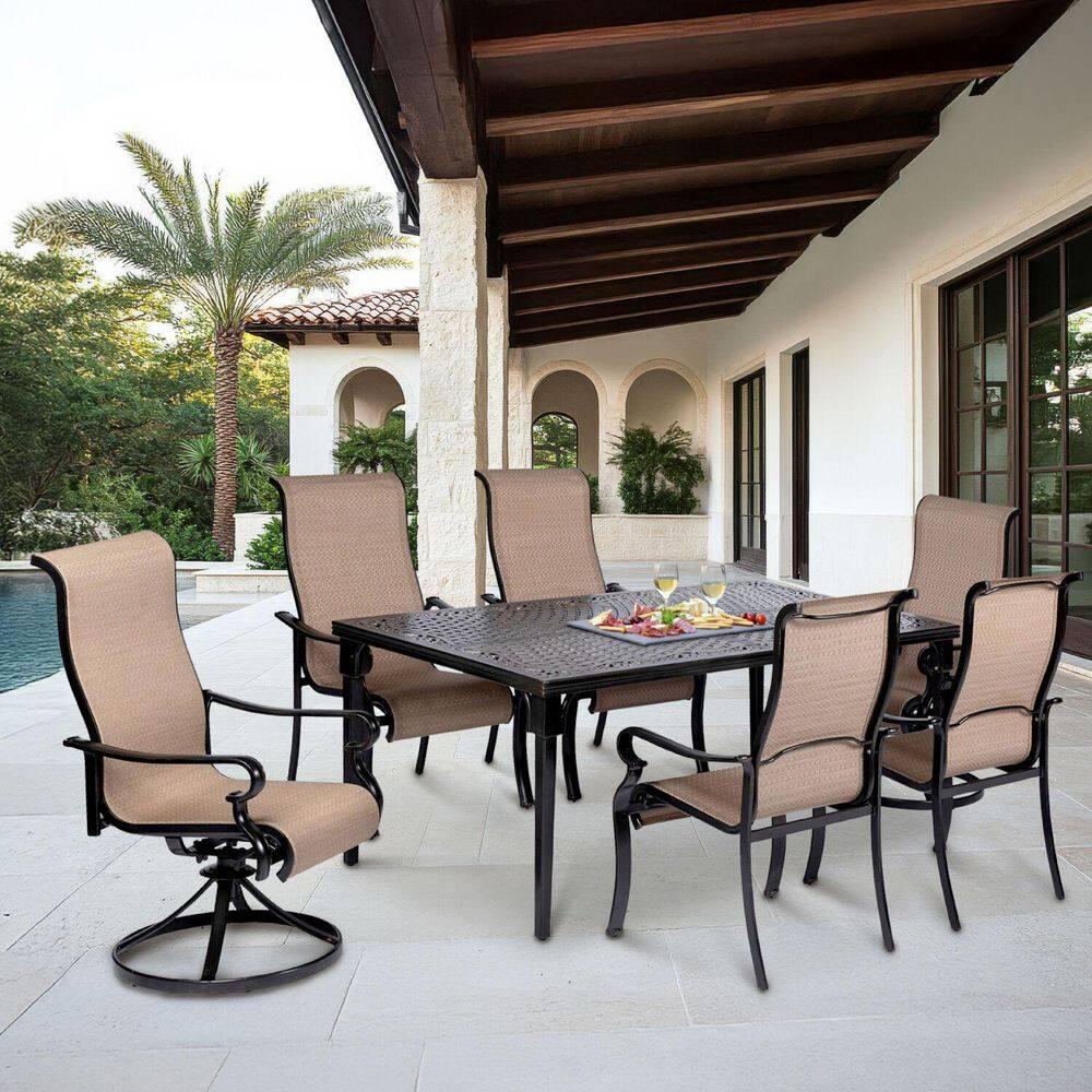 Hanover Brigantine Juego de Comedor Moderno para Exteriores de 7 Piezas / 4 Sillas con Cabestrillo, 2 Balancines Giratorios / Mesa con Tapa de 40'' x 70'' / Clima, Xido, Resistente a UV / Bronceado / BRIGDN7PCSW-2