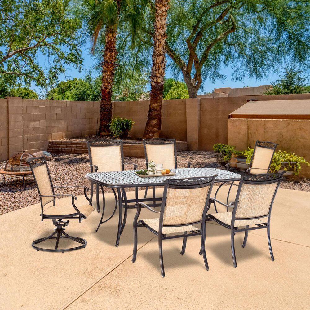 Hanover Fontana 7-Piece Outdoor Dining Set with 2 Sling Swivel Rockers, 4 Sling Chairs, and a 38-In. x 72-In. Cast-Top Table