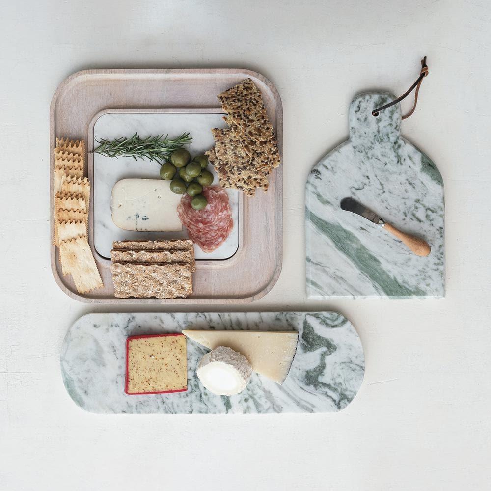 Creative Co-Op Marble And Wood Cutting Board On A Dish
