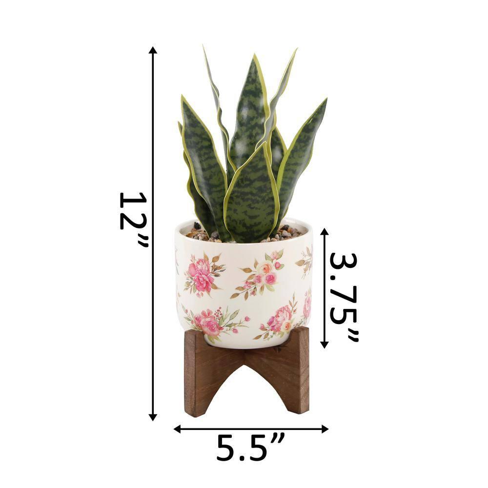 12" Artificial Snake Plant in Floral Print Ceramic Planter on Wood Stand