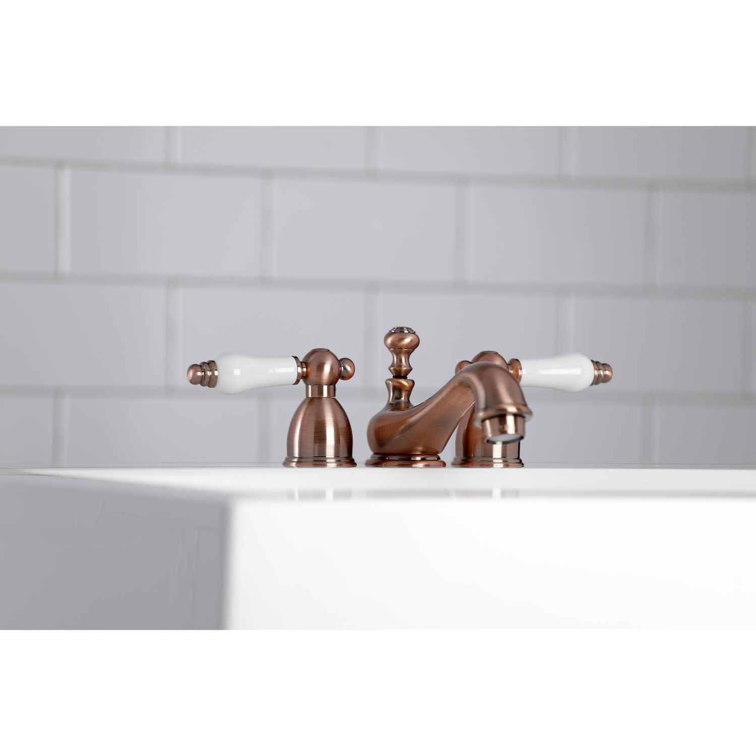 Kingston Brass Restoration Two-Handle 3-Hole Deck Mount Mini-Widespread Bathroom Faucet with Brass Pop-Up