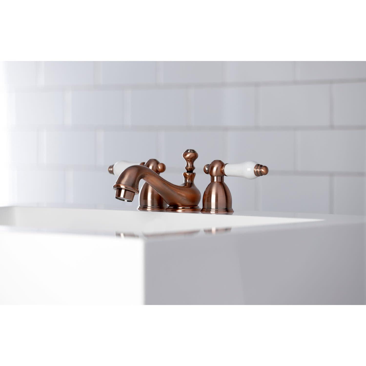 Kingston Brass Restoration Two-Handle 3-Hole Deck Mount Mini-Widespread Bathroom Faucet with Brass Pop-Up