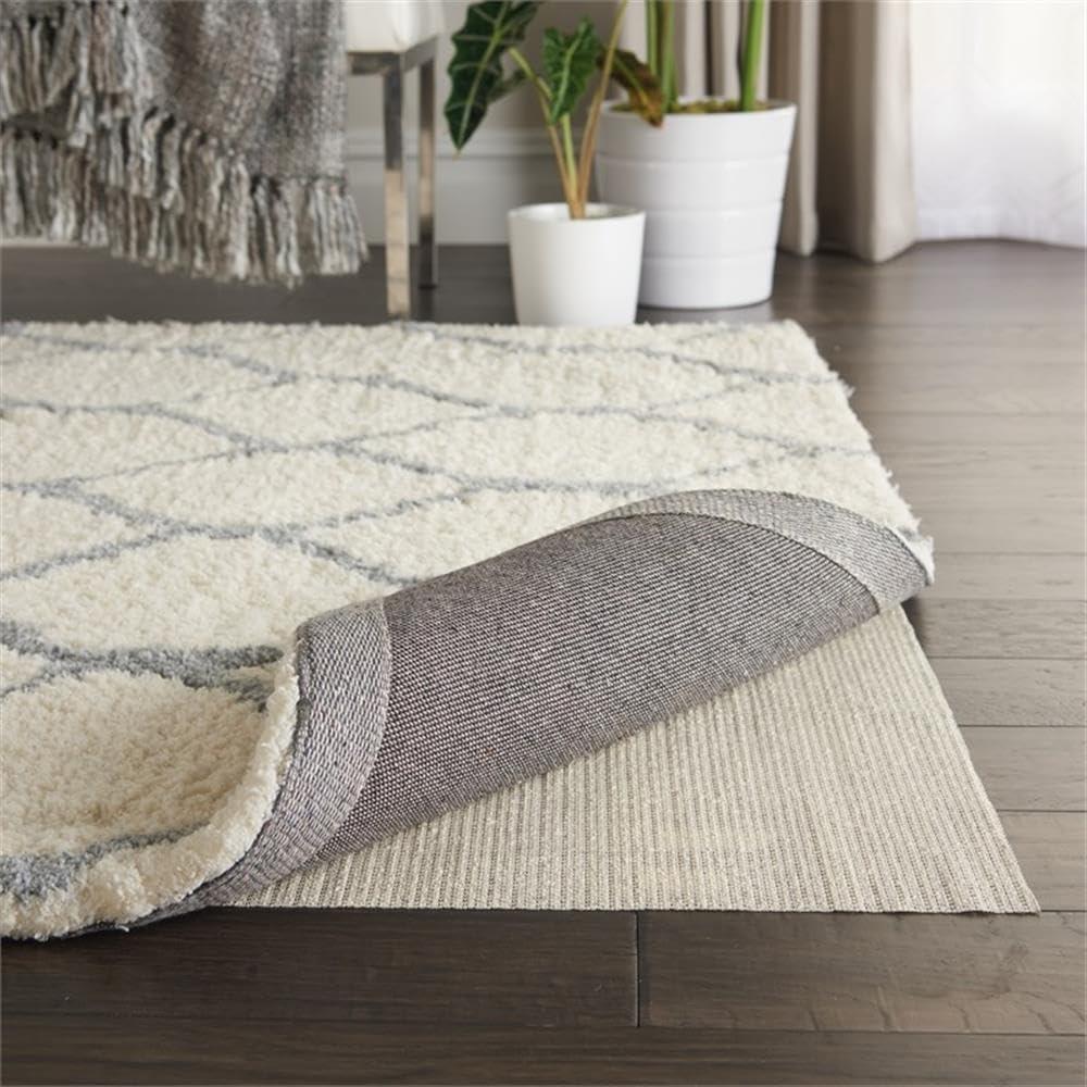 Ebern Designs Rectangle Shiftloc Solid Color Machine Made Polyester/Plastic/Acrylic Area Rug in Ivory