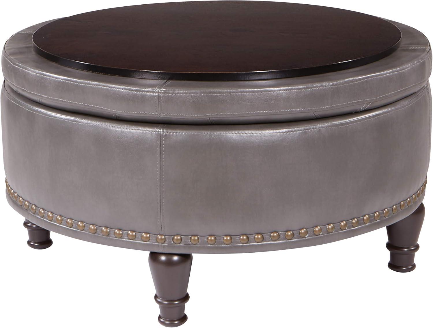 OSP Home Furnishings Augusta Round Storage Ottoman in Pewter Bonded Leather with decorative nailheads