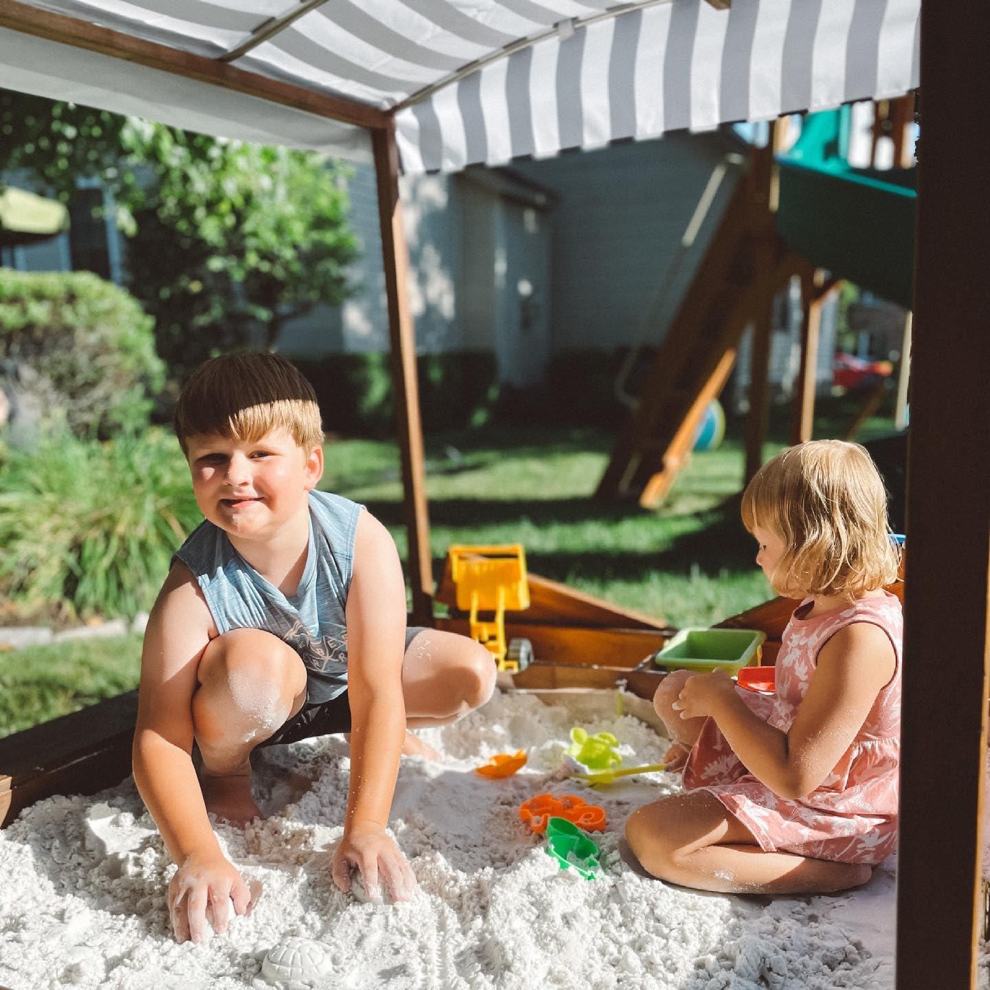 KidKraft Outdoor Covered Wooden Sandbox with Bins and Striped Navy & White Canopy