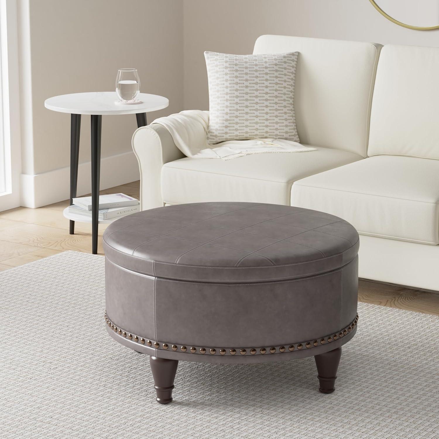 OSP Home Furnishings Augusta Round Storage Ottoman in Pewter Bonded Leather with decorative nailheads