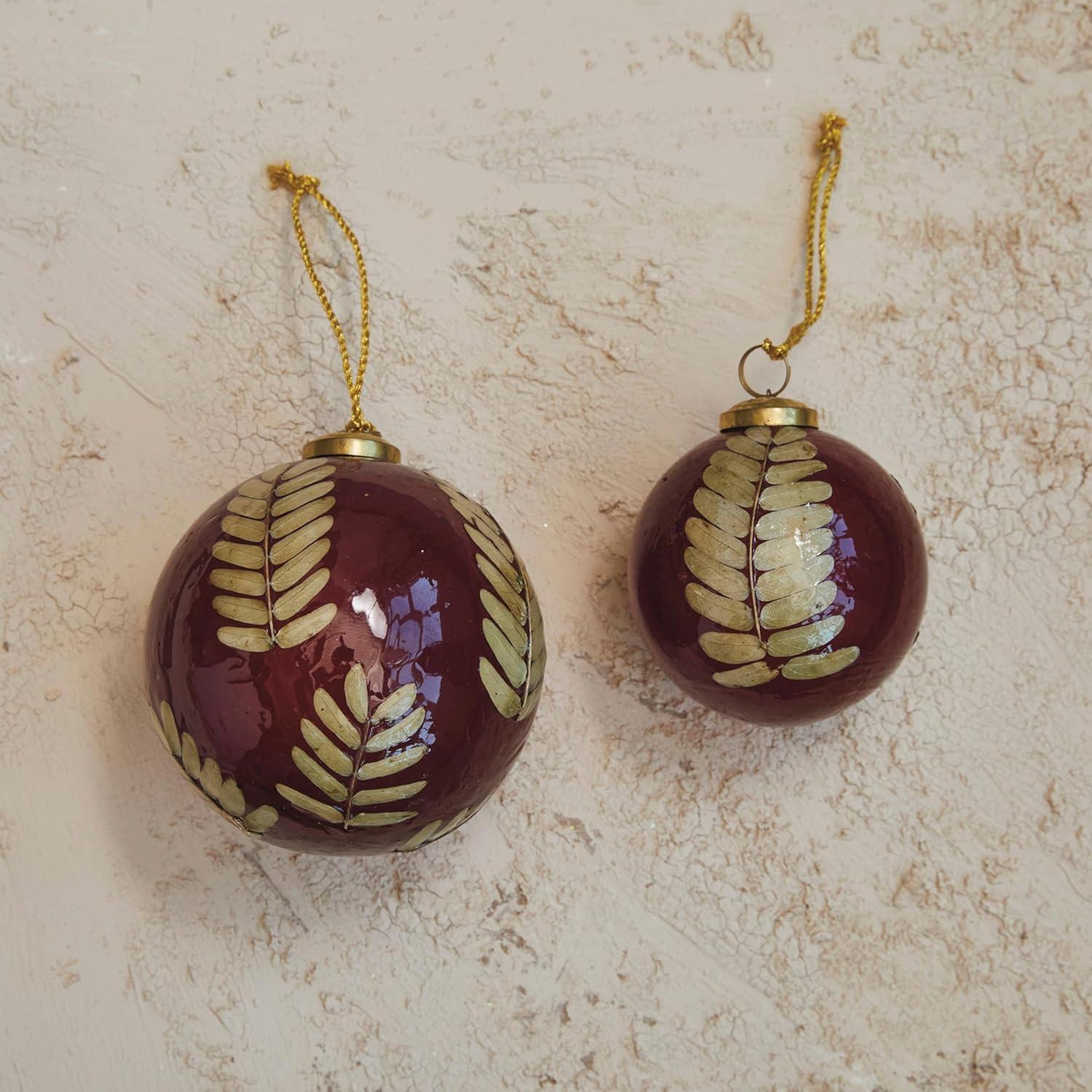 Red and Gold Glass Ornament with Eucalyptus Leaves