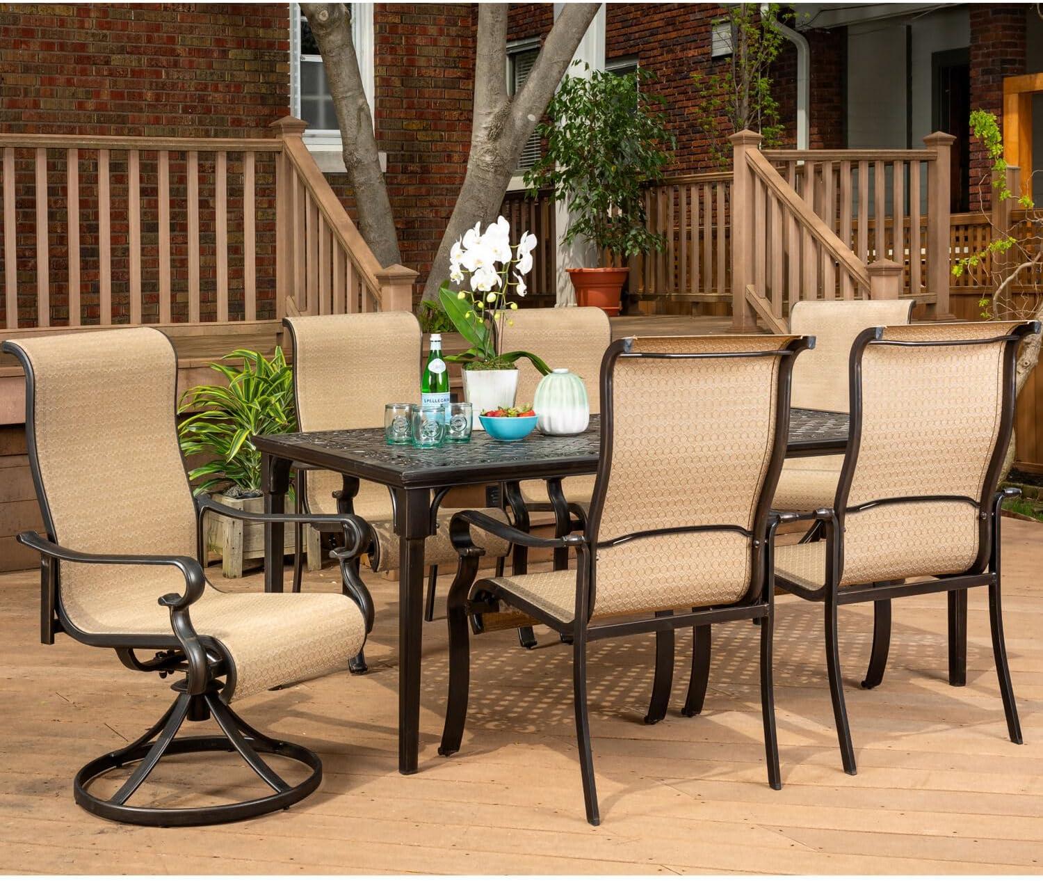 Hanover Brigantine Juego de Comedor Moderno para Exteriores de 7 Piezas / 4 Sillas con Cabestrillo, 2 Balancines Giratorios / Mesa con Tapa de 40'' x 70'' / Clima, Xido, Resistente a UV / Bronceado / BRIGDN7PCSW-2