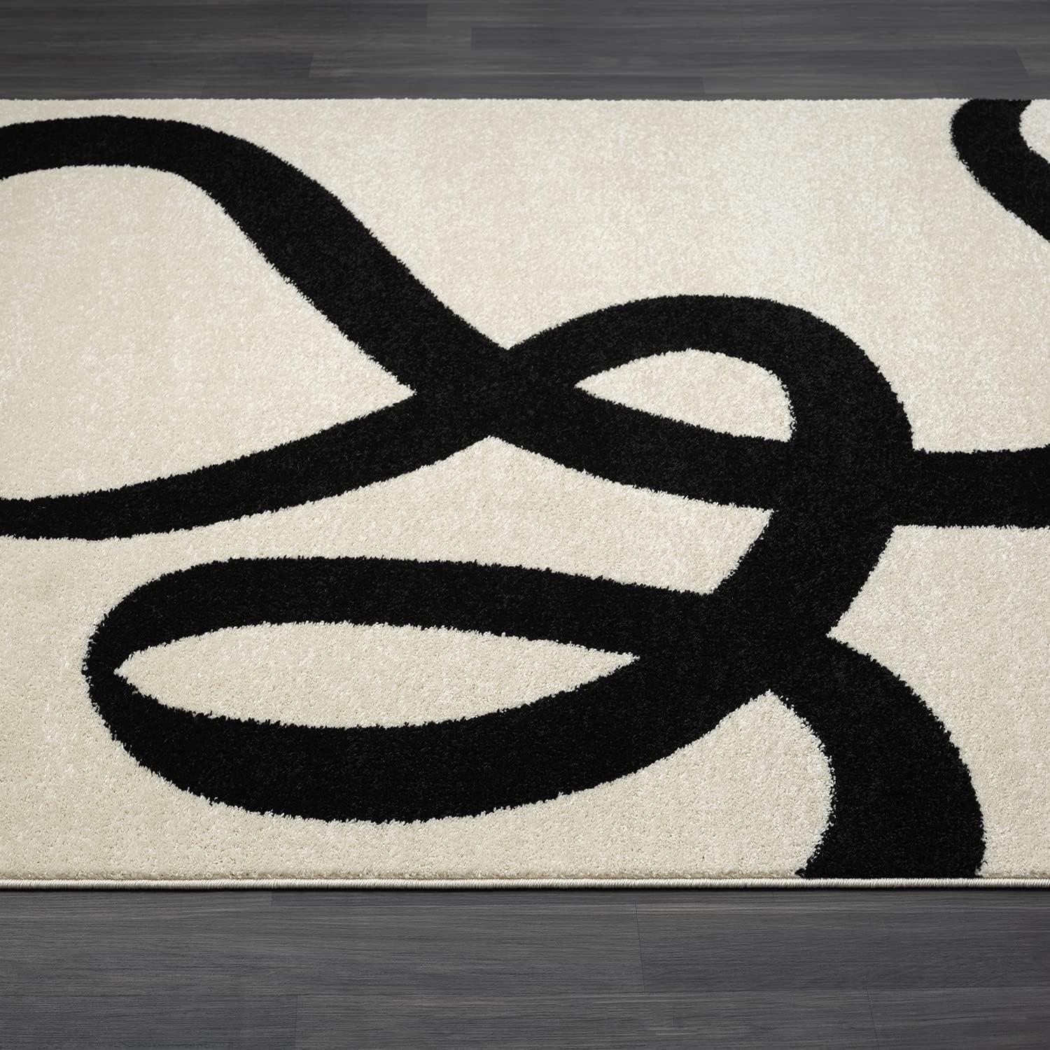 6' x 9' Black and Beige Abstract Rectangular Rug