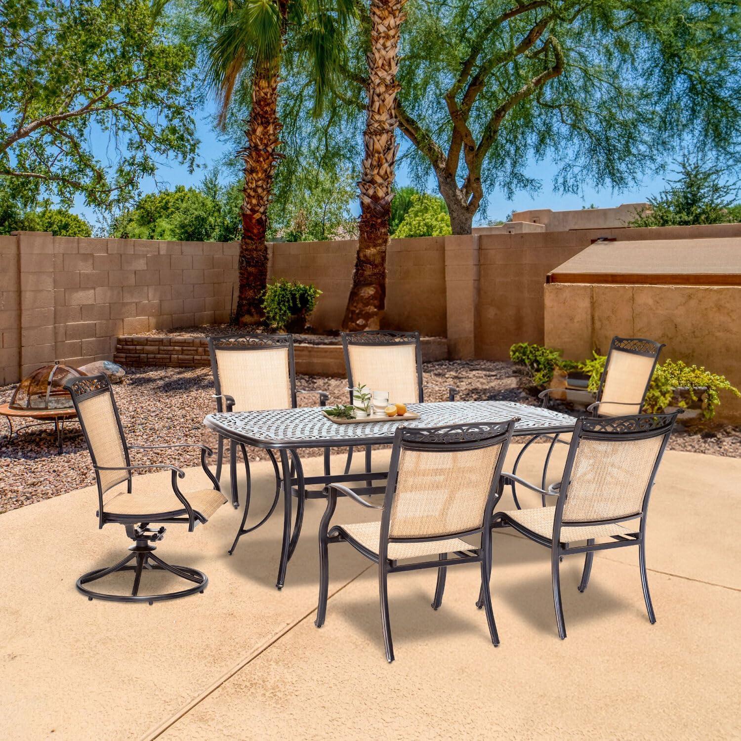 Hanover Fontana 7-Piece Outdoor Dining Set with 2 Sling Swivel Rockers, 4 Sling Chairs, and a 38-In. x 72-In. Cast-Top Table