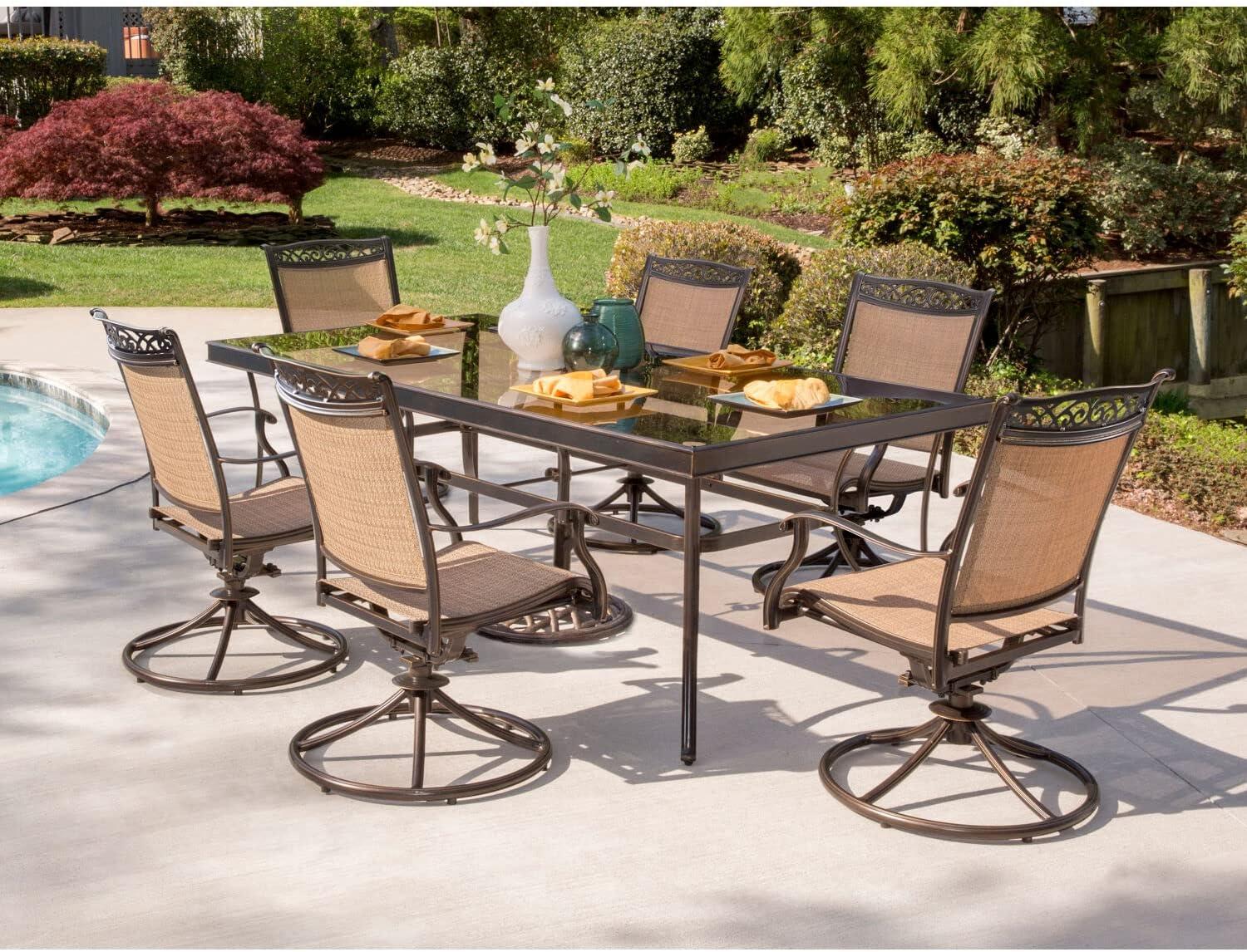 Hanover Fontana 7-Piece Outdoor Dining Set with 2 Sling Swivel Rockers, 4 Sling Chairs, and a 38-In. x 72-In. Cast-Top Table