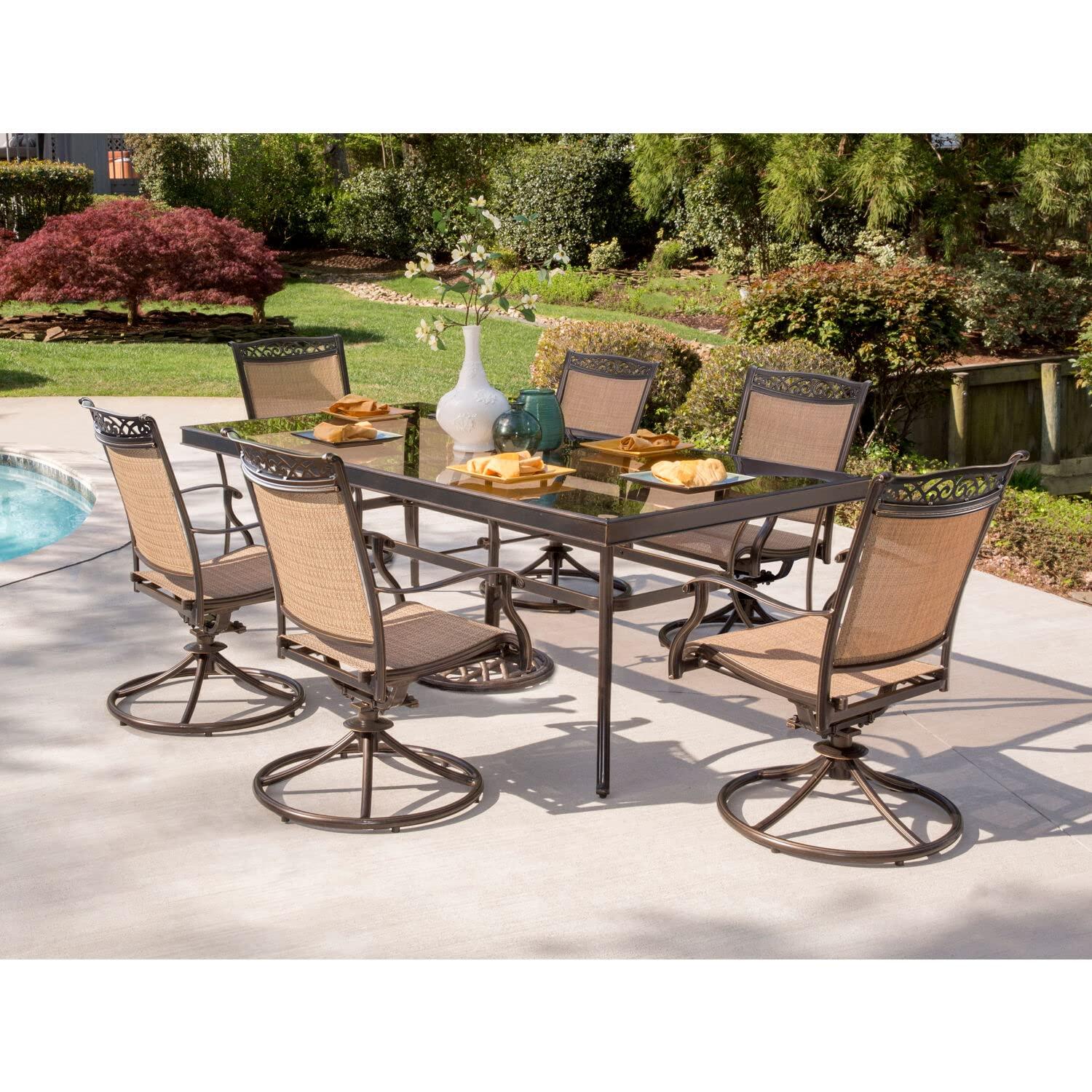 Hanover Fontana 7-Piece Outdoor Dining Set with 2 Sling Swivel Rockers, 4 Sling Chairs, and a 38-In. x 72-In. Cast-Top Table