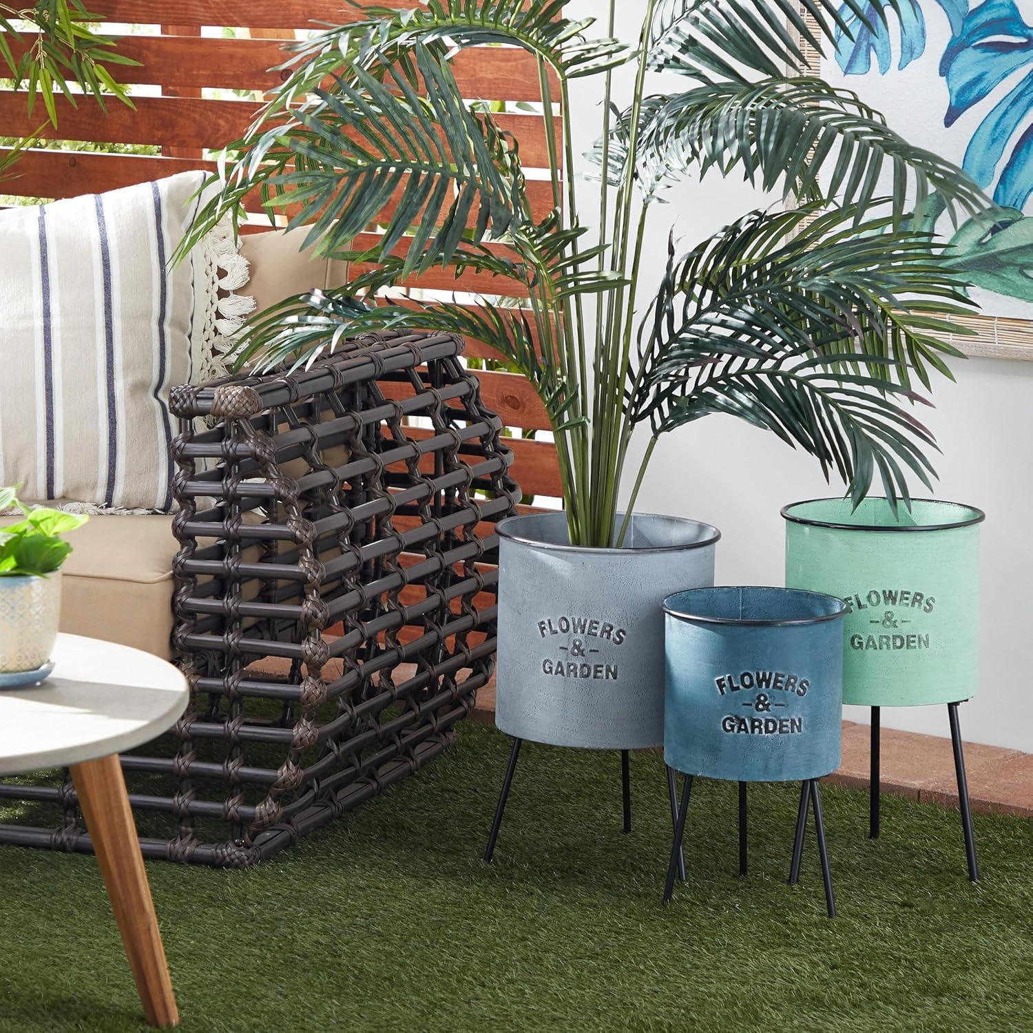 DecMode 20", 18", 16"H Blue Metal Text Planter with Flowers And Garden Text and Black Tripod Legs (3 Count)
