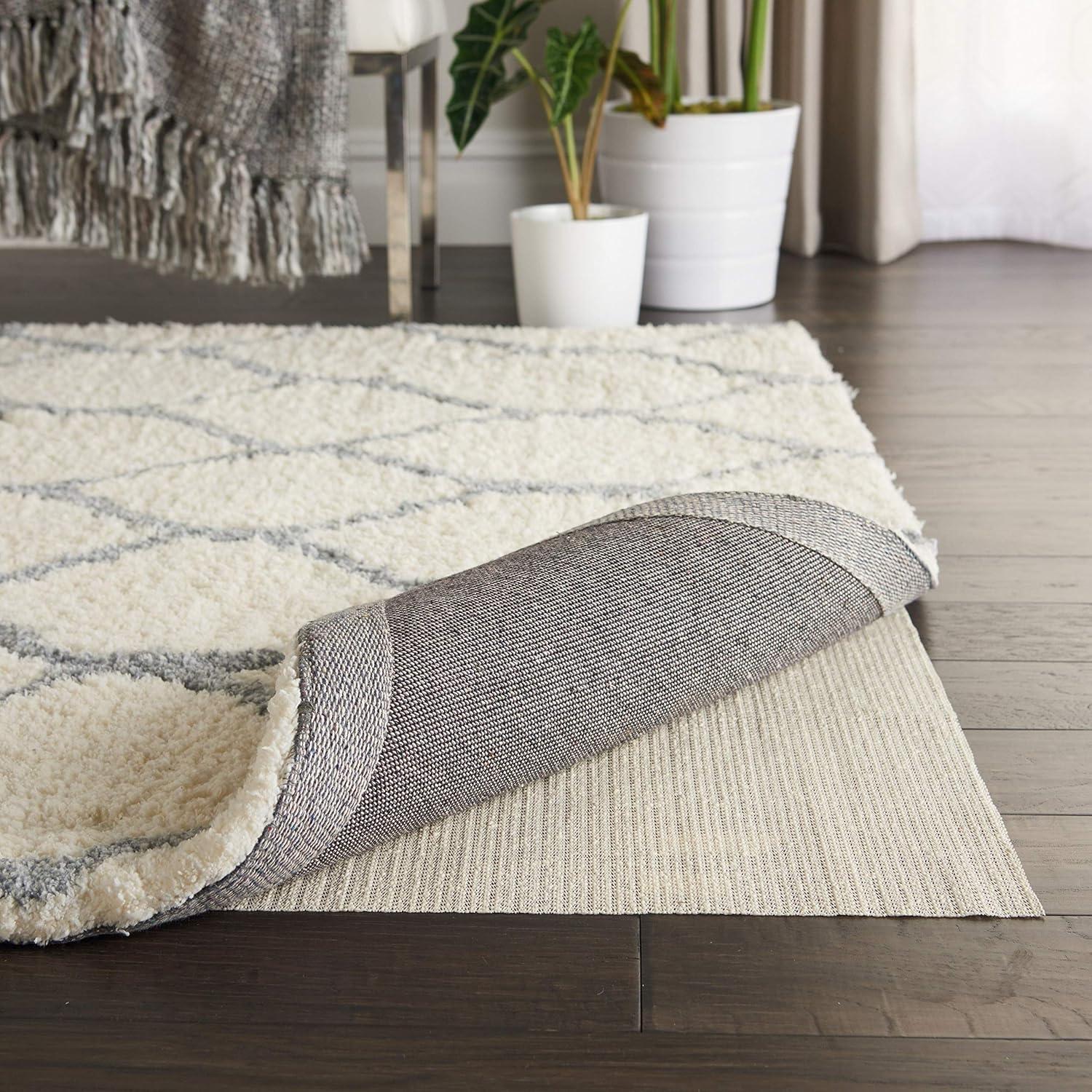 Ebern Designs Rectangle Shiftloc Solid Color Machine Made Polyester/Plastic/Acrylic Area Rug in Ivory