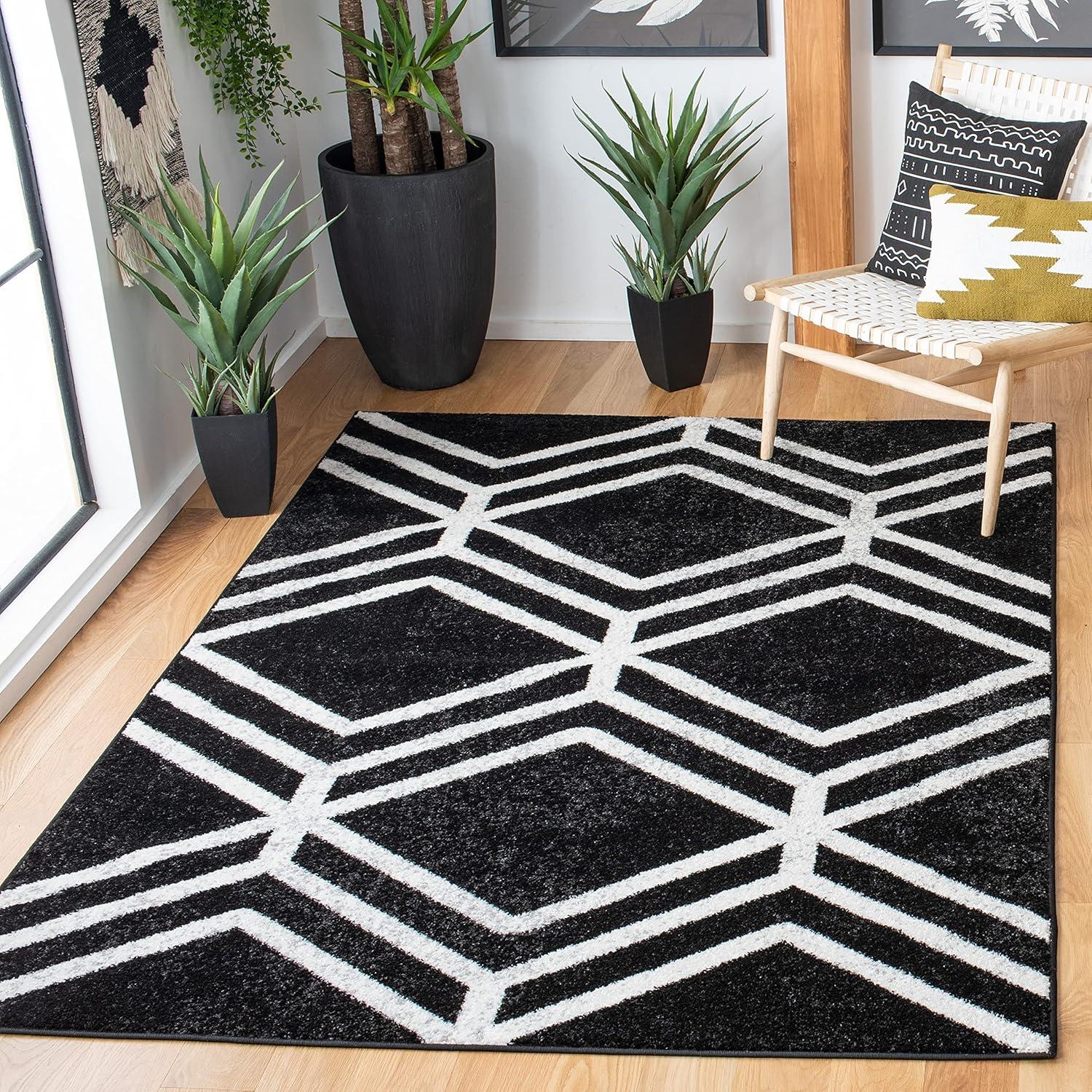 Black and Ivory Geometric 4' x 6' Synthetic Area Rug