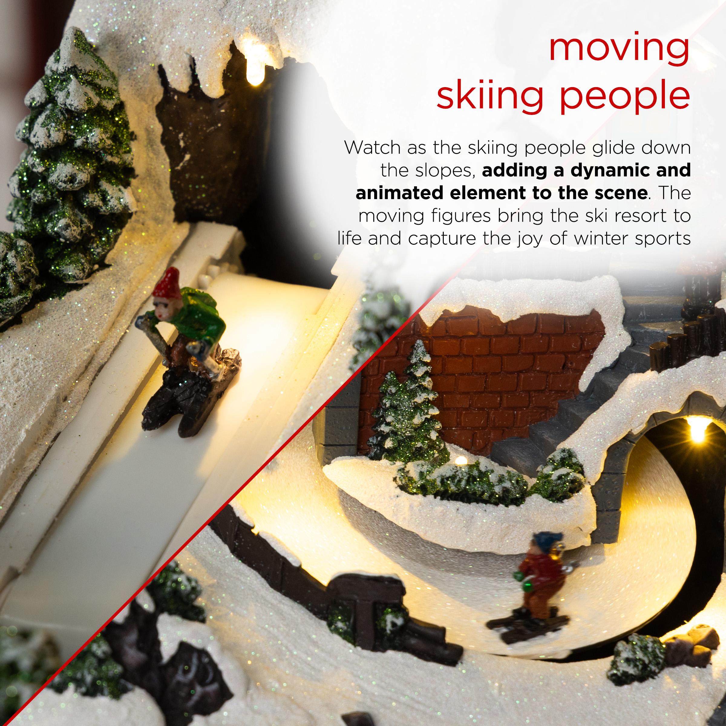 Alpine Corporation Animated Christmas Ski Resort Holiday Tabletop Decor with 12 Warm White LED Lights and Moving Skier Figurines, 12" L x 8" W x 9" H