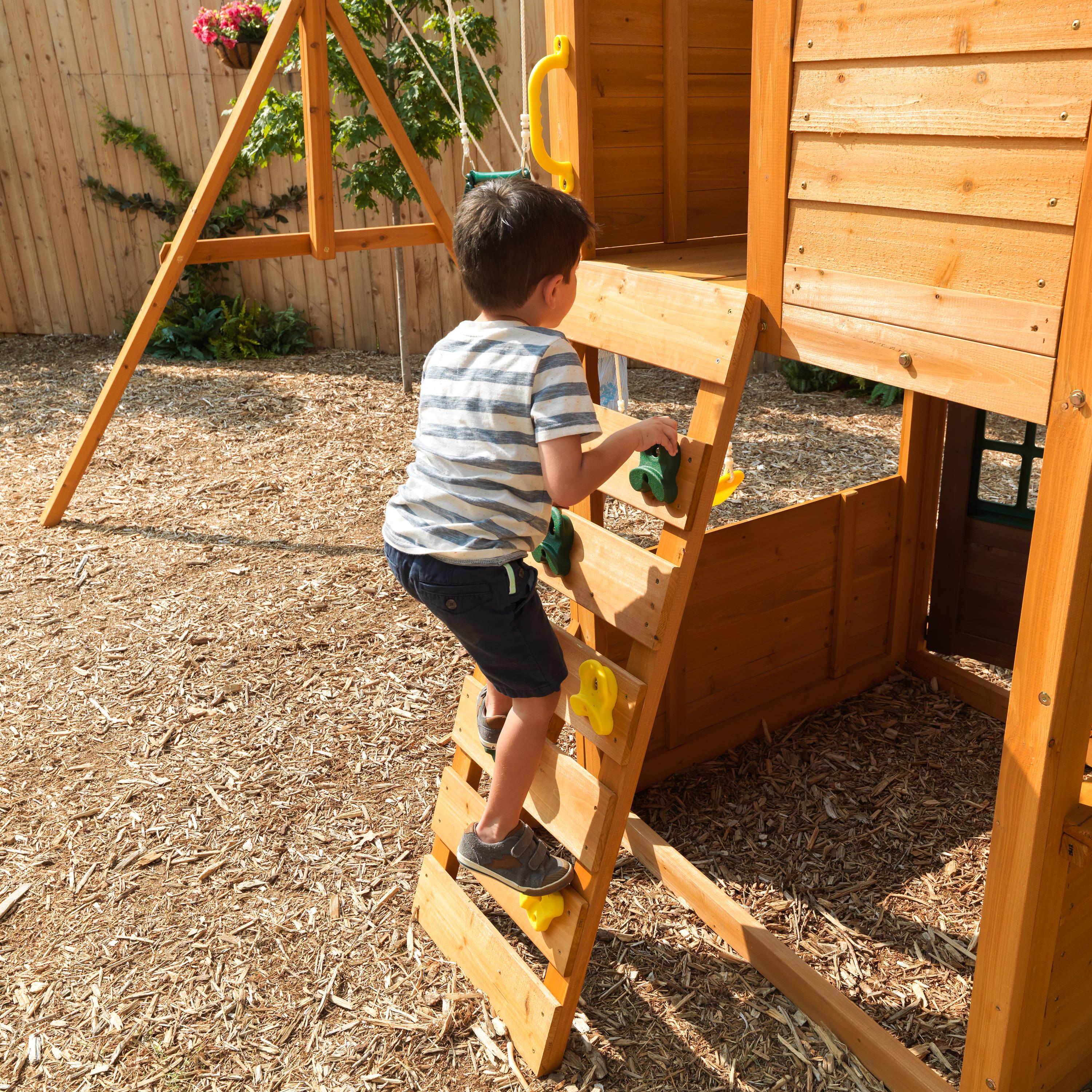 KidKraft Treasure Cove Wooden Swing Set with Slides and Rock Wall